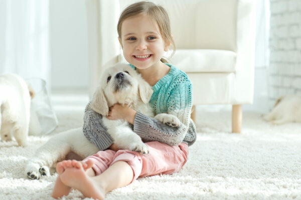 child and dog - carpeted floor